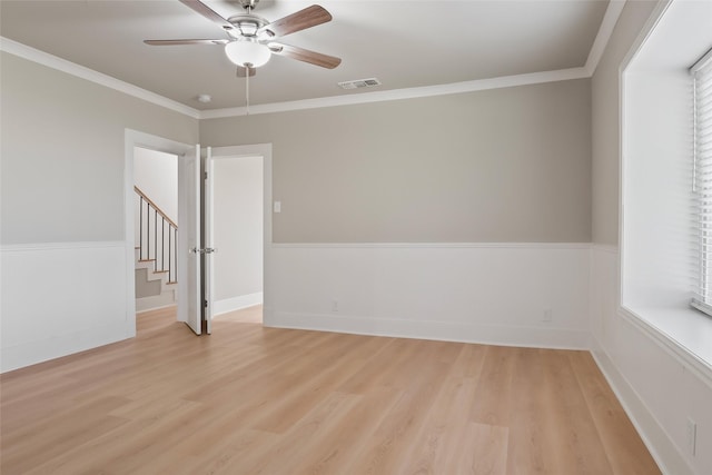 unfurnished room with ceiling fan, light hardwood / wood-style floors, and crown molding