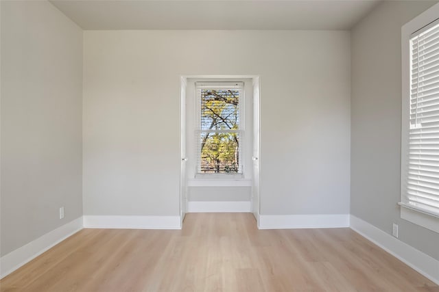 unfurnished room with light wood-type flooring