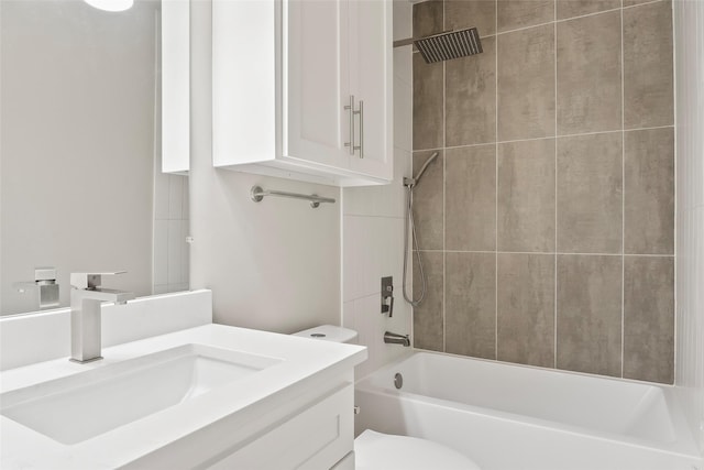 full bathroom with vanity, tiled shower / bath combo, and toilet