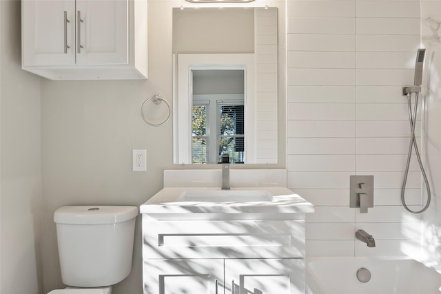 full bathroom with vanity, tiled shower / bath combo, and toilet