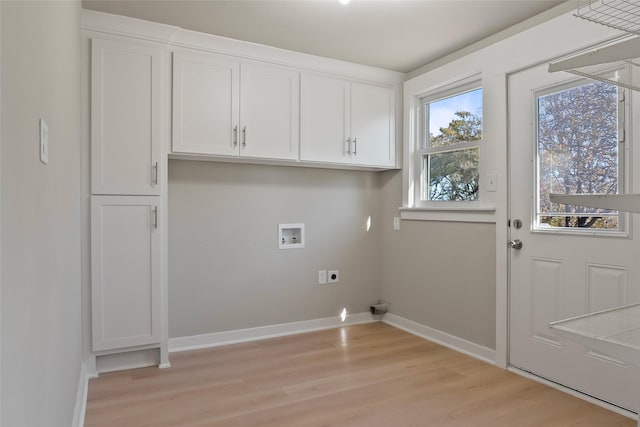 washroom with electric dryer hookup, cabinets, hookup for a washing machine, and light hardwood / wood-style flooring