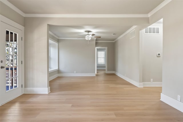 unfurnished room with a wealth of natural light, crown molding, ceiling fan, and light hardwood / wood-style floors