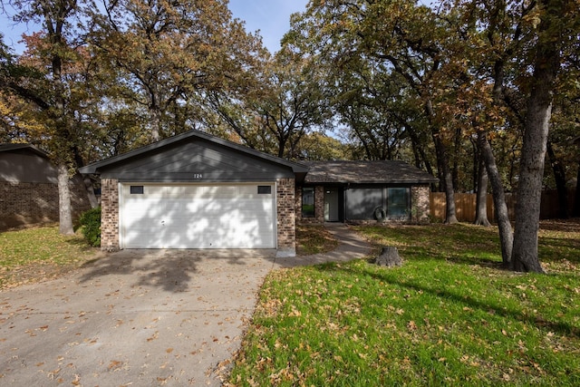 ranch-style house featuring a garage and a front yard