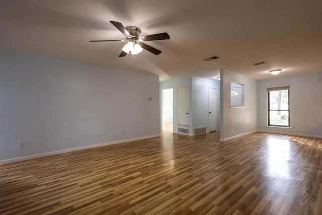 empty room with ceiling fan and dark hardwood / wood-style floors