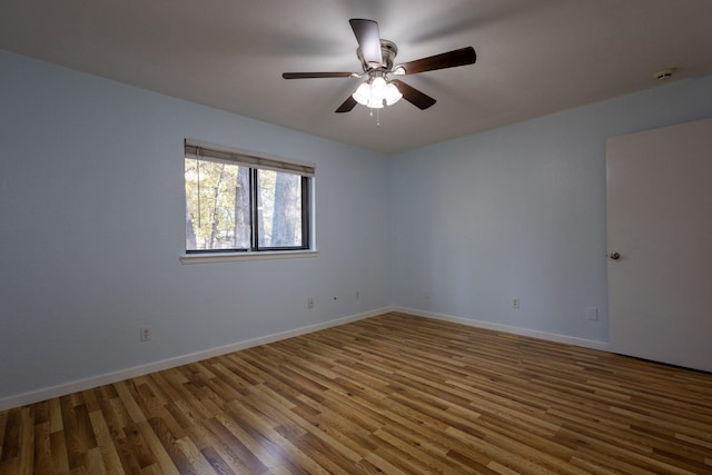 spare room featuring hardwood / wood-style flooring and ceiling fan