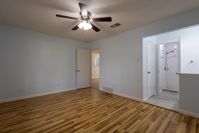 unfurnished bedroom featuring ceiling fan, light wood-type flooring, and ensuite bath