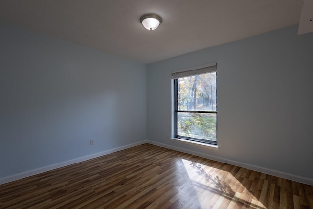 unfurnished room featuring dark hardwood / wood-style floors