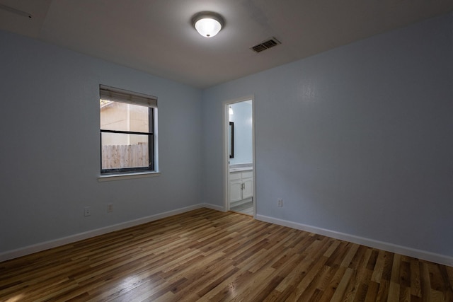 empty room featuring hardwood / wood-style flooring