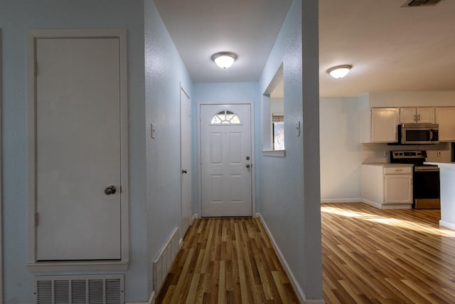 doorway to outside with light hardwood / wood-style flooring