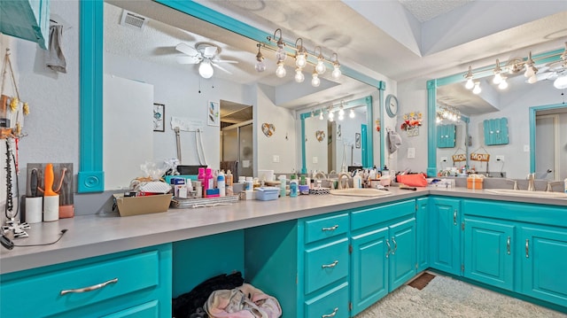 bathroom featuring vanity, a textured ceiling, ceiling fan, and a shower with shower door