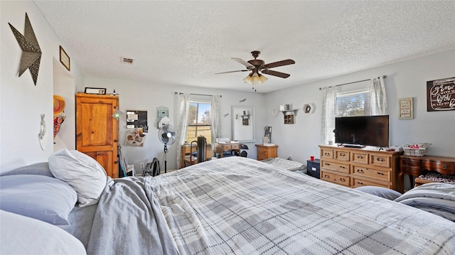 bedroom featuring ceiling fan and a textured ceiling