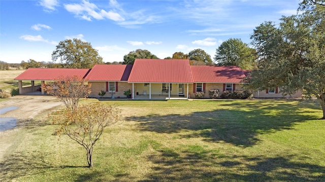 ranch-style home with a front lawn, covered porch, and a carport