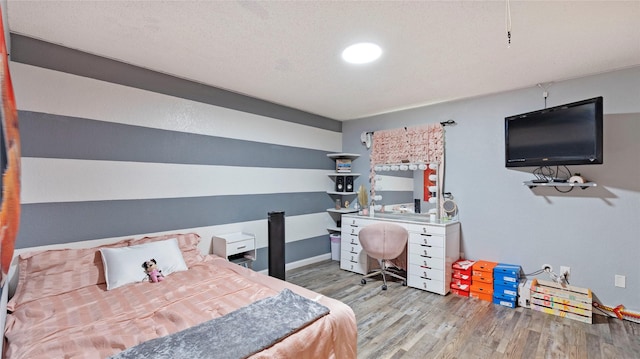 bedroom featuring a textured ceiling and hardwood / wood-style flooring