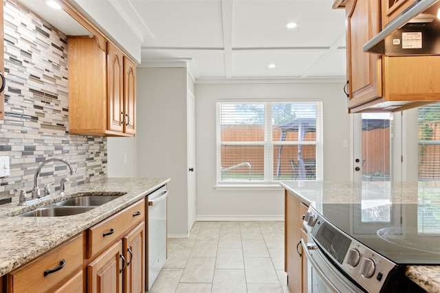 kitchen with sink, appliances with stainless steel finishes, light stone counters, tasteful backsplash, and light tile patterned flooring