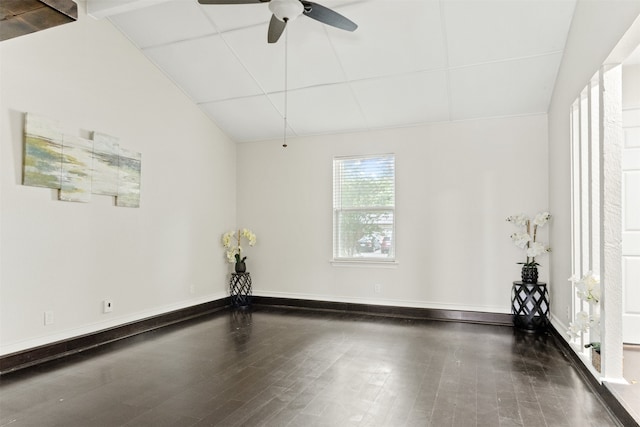 empty room with vaulted ceiling, dark hardwood / wood-style floors, and ceiling fan