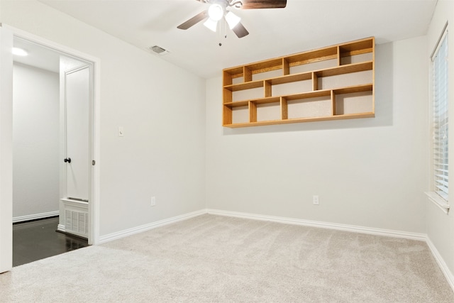 interior space featuring ceiling fan and dark colored carpet