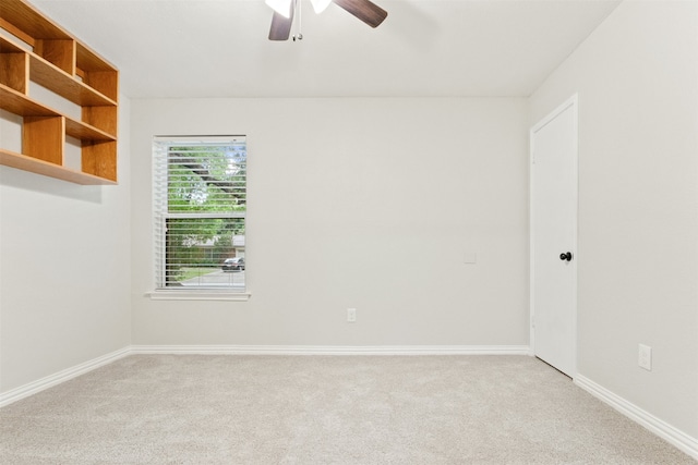 empty room featuring ceiling fan and light carpet