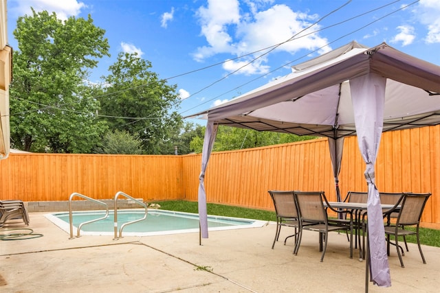 view of swimming pool with a gazebo and a patio area