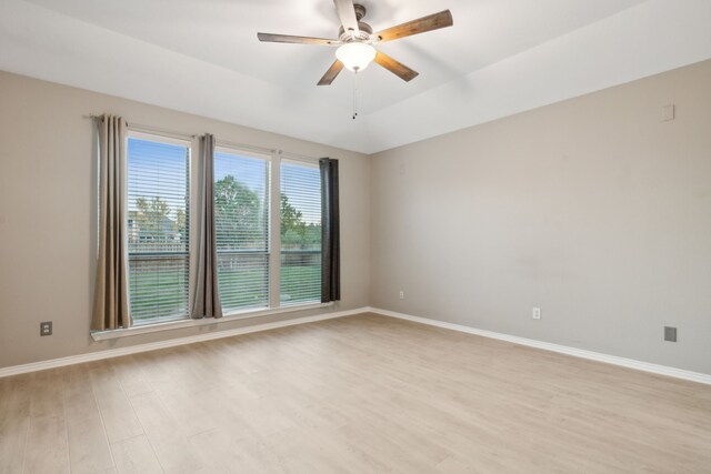 empty room with ceiling fan and light hardwood / wood-style flooring