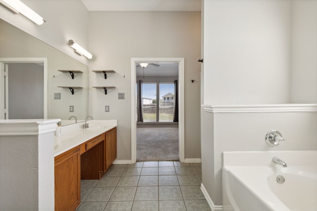 bathroom with tile patterned flooring, vanity, a washtub, and ceiling fan