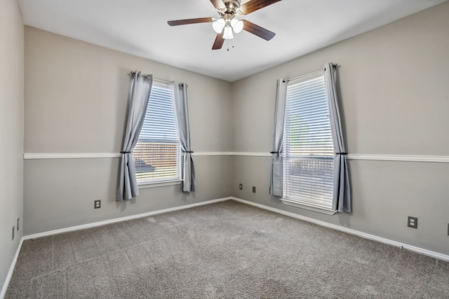 carpeted spare room with ceiling fan