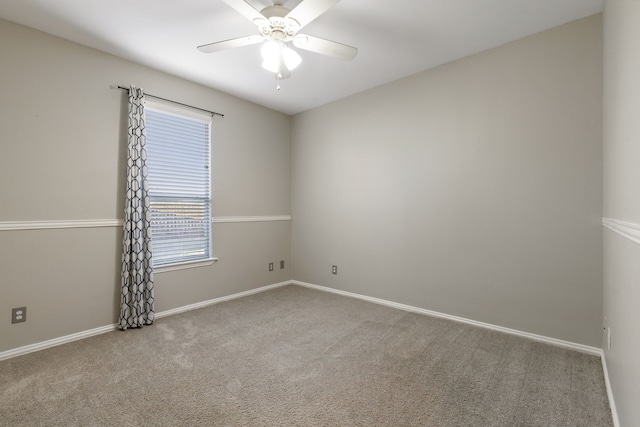 spare room with light carpet and ceiling fan