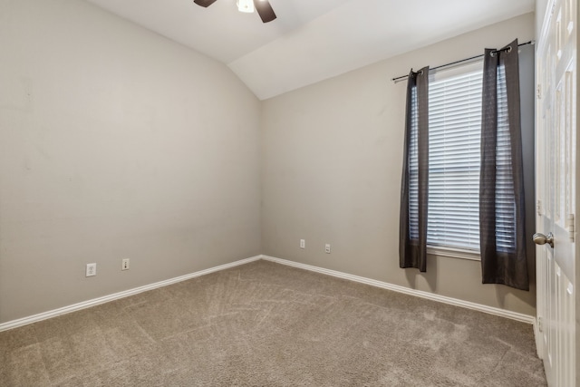 unfurnished room featuring ceiling fan, lofted ceiling, and carpet floors