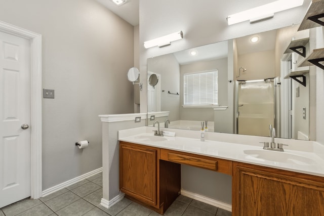 bathroom featuring tile patterned floors, a shower with shower door, and vanity