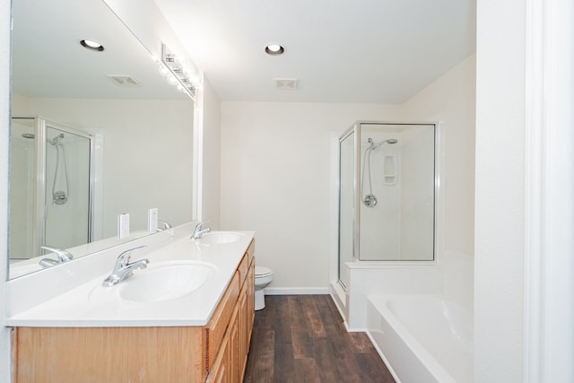 full bathroom with toilet, vanity, wood-type flooring, and shower with separate bathtub