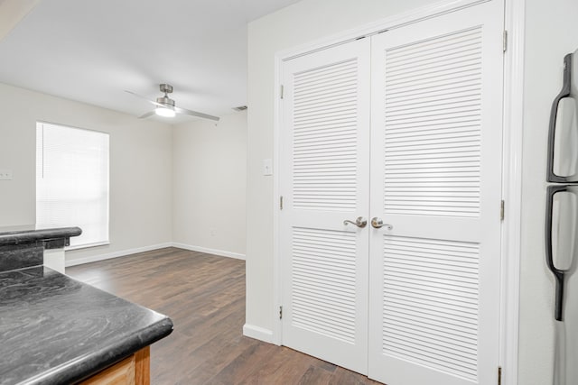 interior space with ceiling fan, stainless steel fridge, and dark hardwood / wood-style flooring