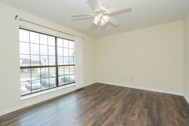 unfurnished room with ceiling fan and dark wood-type flooring