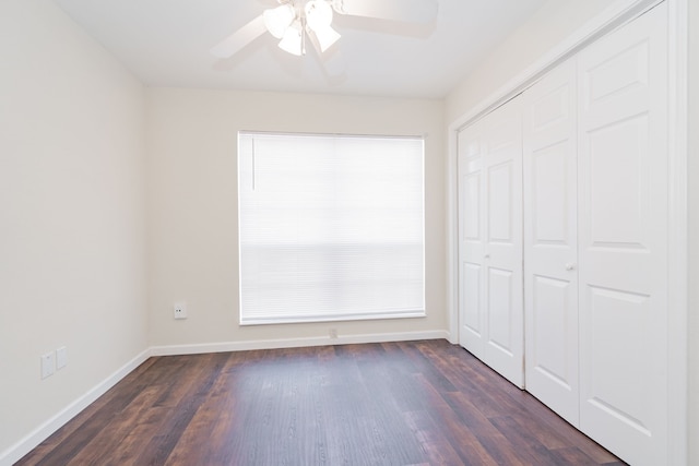 unfurnished bedroom with a closet, dark hardwood / wood-style floors, and ceiling fan