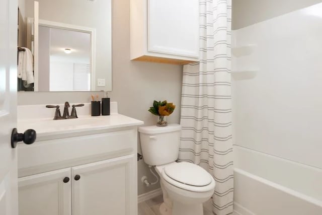 full bathroom with vanity, toilet, and shower / tub combo