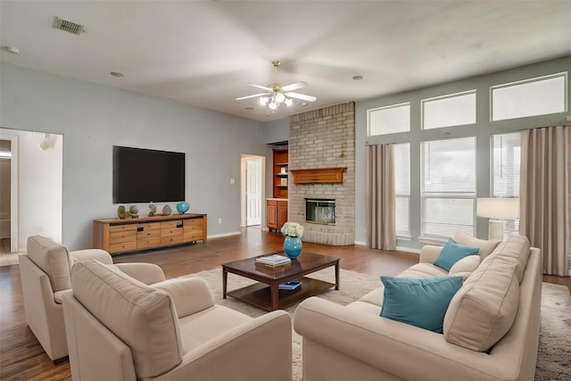 living room featuring hardwood / wood-style floors and a brick fireplace