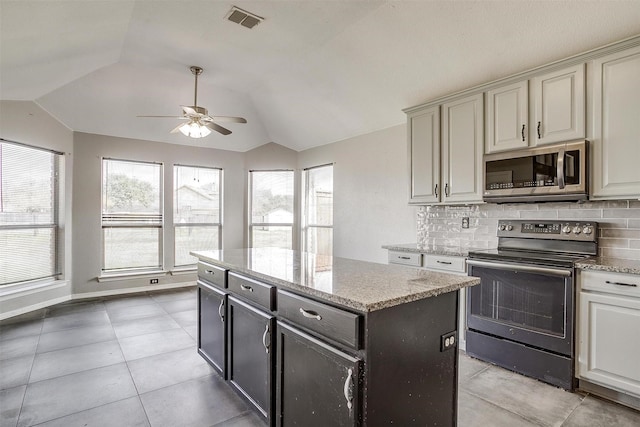 kitchen with backsplash, black / electric stove, ceiling fan, and lofted ceiling