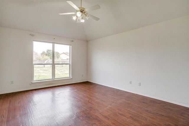 empty room featuring dark hardwood / wood-style flooring, ceiling fan, and lofted ceiling