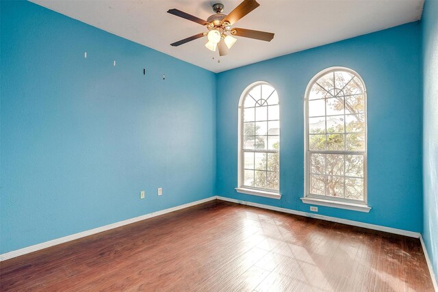 unfurnished room with hardwood / wood-style flooring and ceiling fan