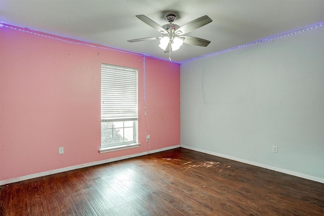 empty room with ceiling fan and dark wood-type flooring