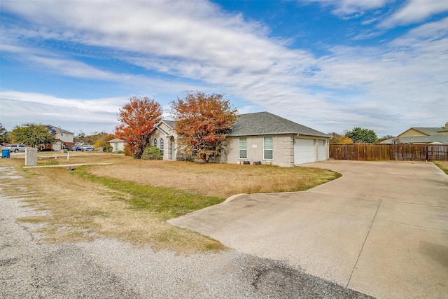 view of side of property with a yard and a garage