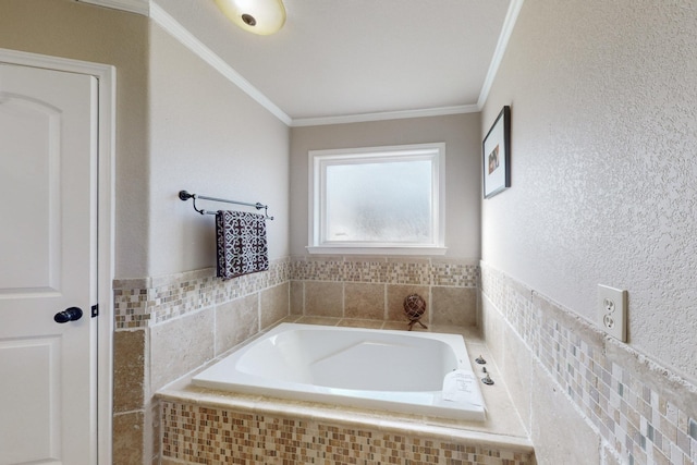 bathroom with ornamental molding and tiled tub