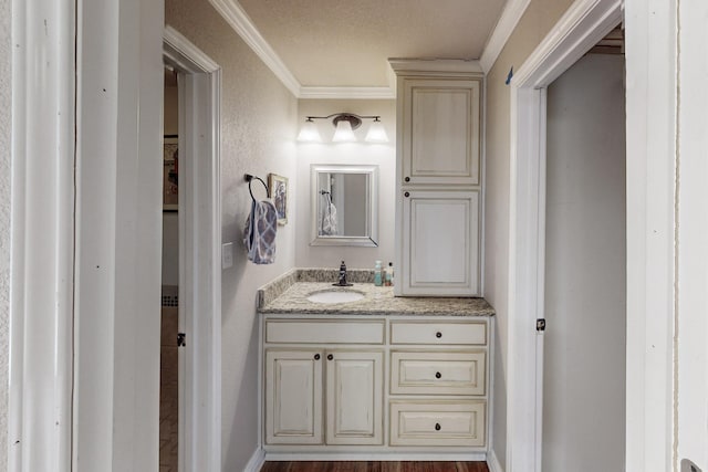 bathroom featuring vanity, crown molding, a textured ceiling, and hardwood / wood-style floors