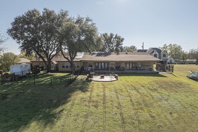 back of house with a lawn and a patio