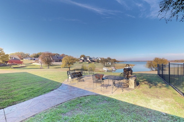 view of yard with a water view and a patio