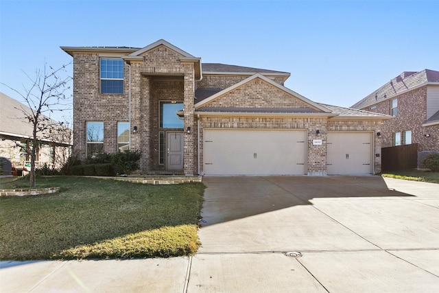 view of front of property featuring a front yard and a garage