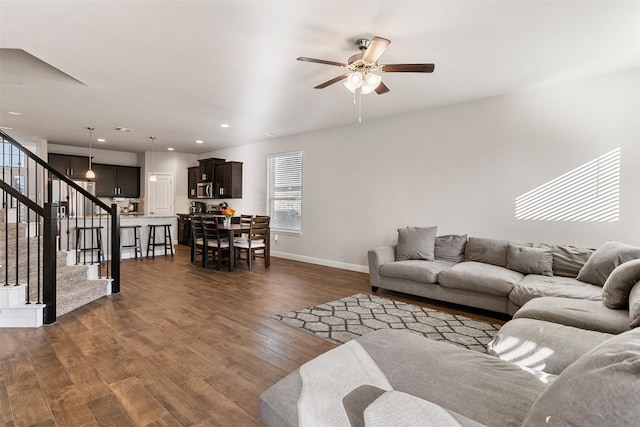 living room featuring dark hardwood / wood-style floors and ceiling fan