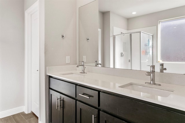 bathroom featuring hardwood / wood-style floors, vanity, and an enclosed shower