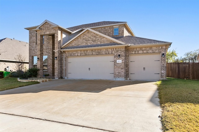 view of front of property with a garage and a front yard