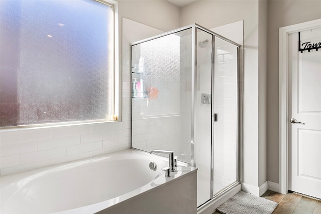 bathroom featuring hardwood / wood-style floors and plus walk in shower