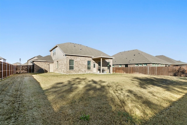 rear view of property featuring a lawn