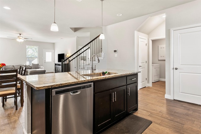 kitchen with sink, hanging light fixtures, stainless steel dishwasher, a center island with sink, and light wood-type flooring